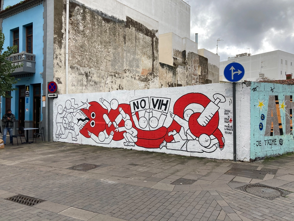 a urban art mural of characters and persons fighting a giant red snake front perspective